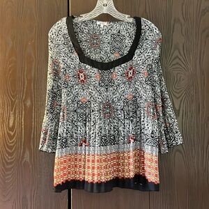Nicola 3/4 sleeved black top with orange and tan floral. Size Medium.